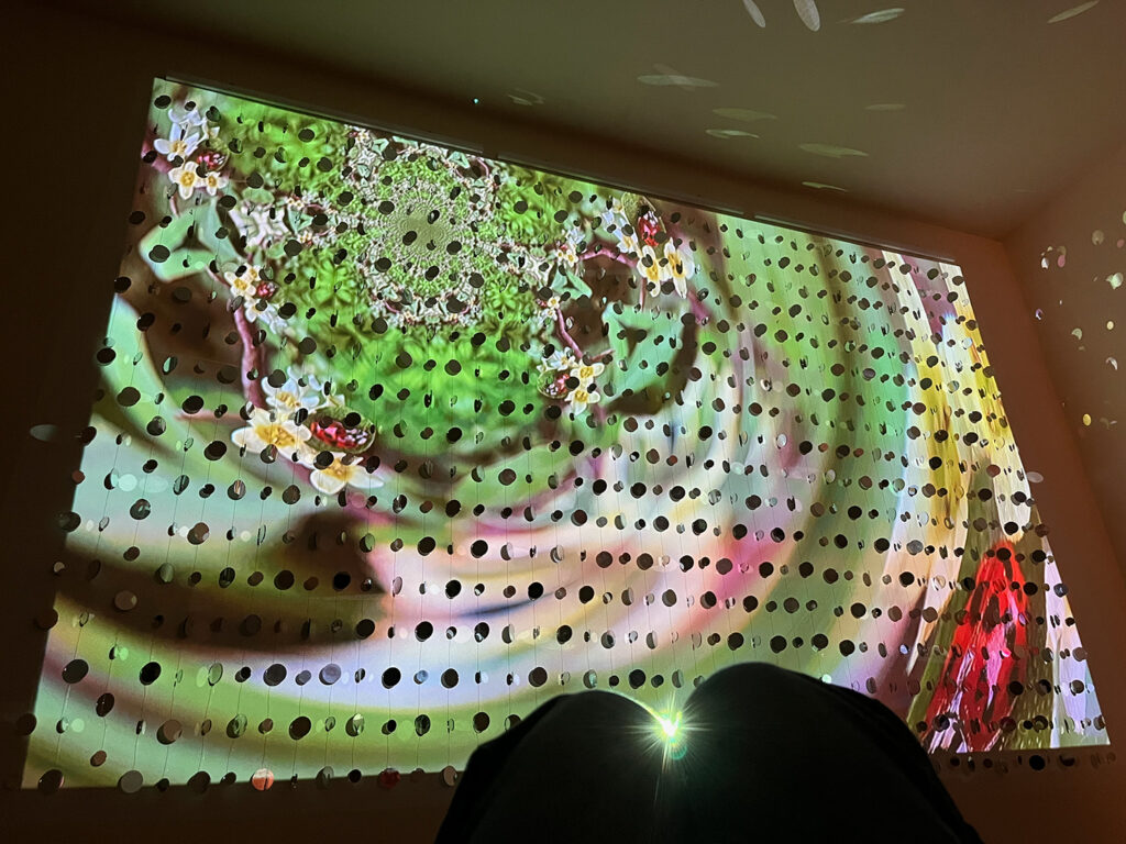 Colorful video projection on mirrored wall